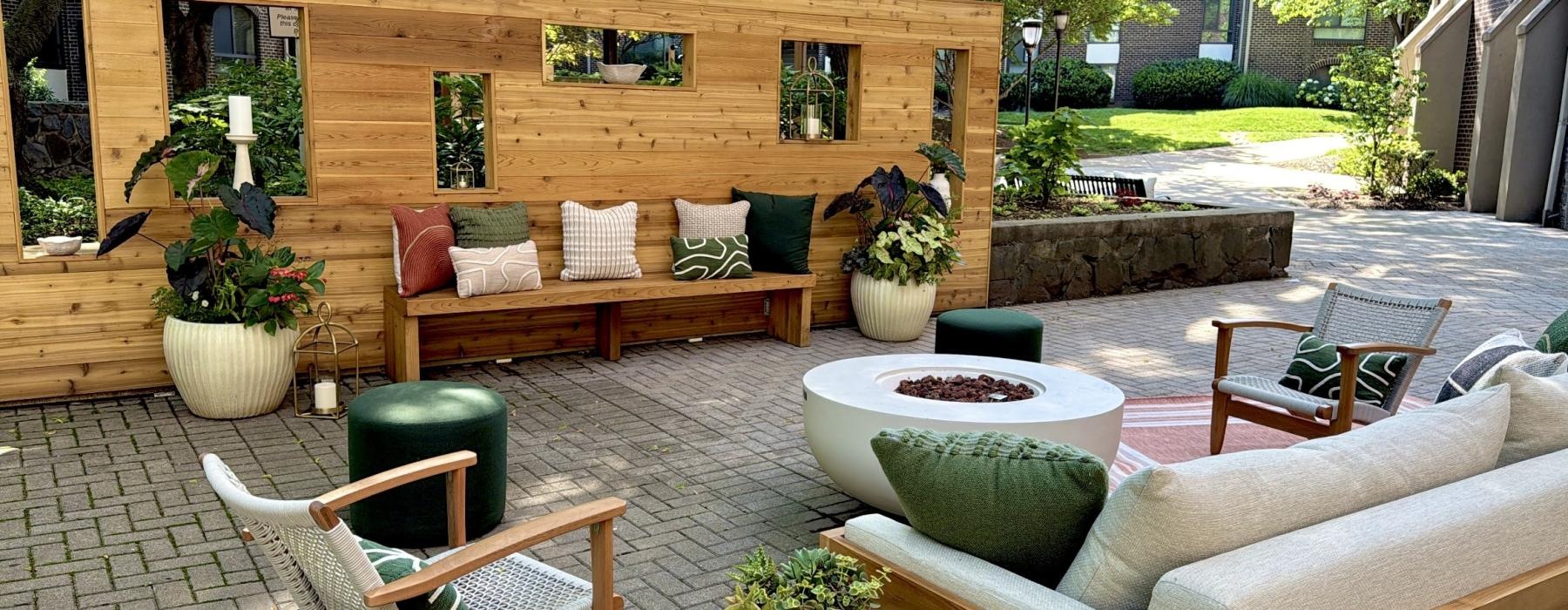 a patio with a bench and chairs