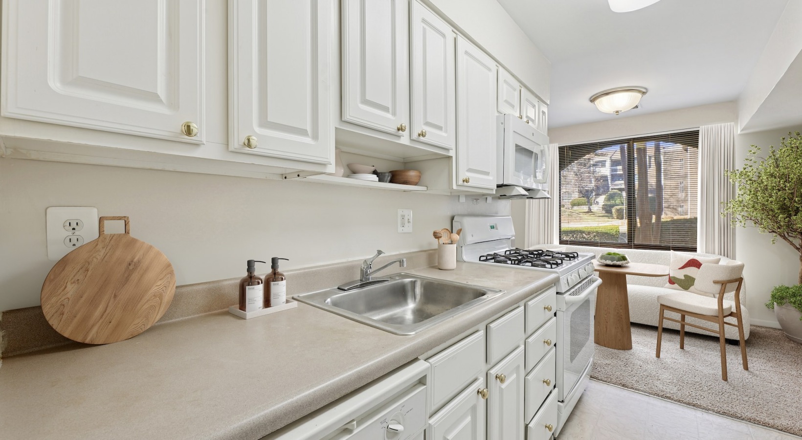 Kitchen counter with dining room chairs in distance
