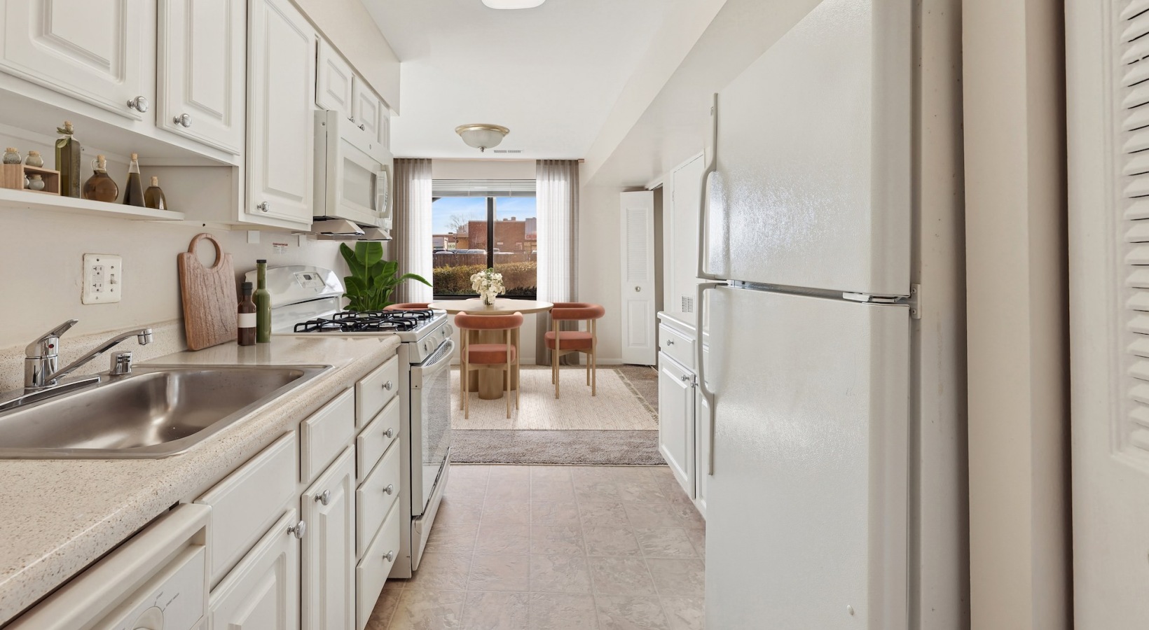 Kitchen counter with dining room chairs in distance